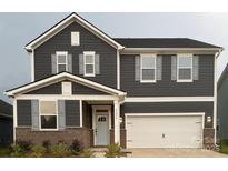 Charming two-story home with a brick foundation, two-car garage, and gray siding at 5239 Scotts Creek Rd, Indian Land, SC 29707