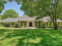 Stunning home with a lush front lawn, mature trees, and a welcoming front entrance and beautiful architecture at 643 Baron Rd # 8, Waxhaw, NC 28173