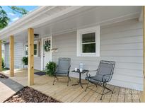 Cozy front porch with seating, plants and decorative wreath on front door of charming home at 73 20Th Sw Ave, Hickory, NC 28602