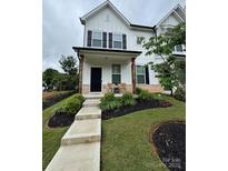 Charming two-story home with a welcoming front porch, well-manicured landscaping, and a freshly painted white exterior at 734 Herlong Ave, Rock Hill, SC 29732