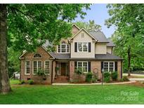 Charming two-story brick home with manicured lawn and beautiful, mature trees at 901 Brighton Dr, Kannapolis, NC 28081