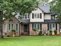 Charming two-story brick home with a well-manicured lawn, mature trees, and inviting curb appeal at 901 Brighton Dr, Kannapolis, NC 28081