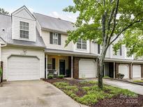 Charming townhome featuring a one-car garage, landscaped front yard, and a welcoming front porch at 9530 Elizabeth Townes Ln, Charlotte, NC 28277