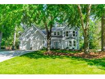 Charming two-story home with landscaped yard and mature trees giving it curb appeal at 9920 White Cascade Dr, Charlotte, NC 28269
