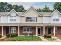 Charming townhome features brick facade, well-maintained landscaping, and cozy front porch at 10548 English Setter Way, Charlotte, NC 28269