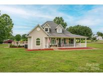 Charming home with a large front porch, green shutters, a dormer, and a spacious yard at 112 Ocean Dr, Shelby, NC 28152