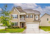 Charming two-story home with a welcoming front porch, manicured lawn, and attached two-car garage at 150 W Morehouse Ave, Mooresville, NC 28117