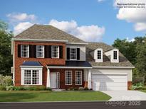 Charming two-story home with classic brick facade, black shutters, and a well-manicured lawn at 1540 Croydon St, Indian Land, SC 29707