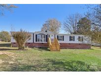 Charming home with a well-maintained lawn, inviting entrance, and beautiful brick foundation at 2315 Circle Dr, Great Falls, SC 29055