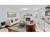 Inviting living room features a cozy fireplace, stylish furniture, and bright natural light at 3308 Selwyn Farms Ln # 5, Charlotte, NC 28209