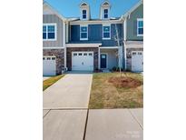 Charming townhome featuring a brick facade, attached garage, and well-maintained landscaping at 4009 Lawnview Dr, Charlotte, NC 28269