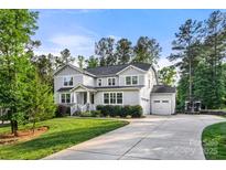 Charming two-story home with a well-manicured lawn, attached garage, and wide driveway at 4189 Island Fox Ln, Denver, NC 28037