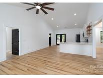 Bright open-concept living room with vaulted ceilings and a modern kitchen at 420 Sloop St, China Grove, NC 28023