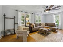 Bright living room with ceiling fan, neutral walls, and comfortable seating, creating a cozy atmosphere at 4230 Train Chaser Pl, Indian Land, SC 29707