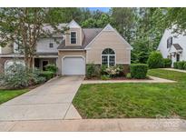 Charming home featuring a manicured lawn, attached garage, and beautiful landscaping at 4557 Panther Pl, Charlotte, NC 28269
