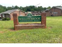 Willowbrook Condominium Homes signage with brick accents surrounded by a grassy lawn at 484 Willow Spring Ln # A, Rock Hill, SC 29730