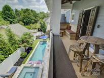 Balcony view of the backyard, showcasing the swimming pool and patio area perfect for relaxing at 628 Bracket St, Fort Mill, SC 29708