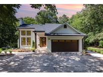 Charming painted-brick home featuring a two-car garage, and a welcoming front porch at 6639 Camp Creek Rd, Lancaster, SC 29720