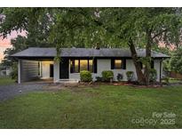 Charming single-story home featuring a carport, painted brick, and manicured lawn at 818 Stowe Ln, Gastonia, NC 28056