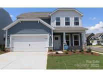 Charming two-story home featuring a pristine white garage door and inviting covered porch at 8614 Acadia Pkwy, Sherrills Ford, NC 28673