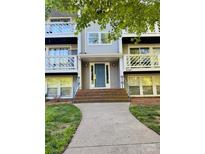 Inviting front entrance with teal door, brick steps and pathway to this charming home at 9541 Shannon Green Dr # C, Charlotte, NC 28213