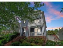 Inviting two-story home with double porches, perfect for enjoying the outdoors at 14034 Holly Springs Dr, Huntersville, NC 28078