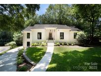 Charming white brick home featuring a well-manicured lawn and elegant front entrance at 1408 Rinehart Ct, Charlotte, NC 28270