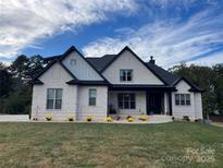 Charming, modern home with white brick, black trim, and lush green lawn at 1427 Kinks Ln # 47, Maiden, NC 28650