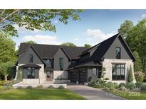 Stunning two-story home featuring a stone and board and batten facade and three-car garage at 20000 Schooner Dr, Cornelius, NC 28031