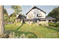 Charming Tudor-style home with stone accents, gabled roof, and beautifully landscaped front yard at 2413 Cross Country Rd, Charlotte, NC 28270