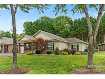 Charming single-story home with manicured lawn and mature trees at 2561 26Th Ne Ave, Hickory, NC 28601
