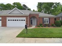 Charming brick home featuring a two-car garage and a well-manicured lawn at 3814 Misty Glen Ct, Matthews, NC 28105