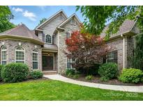 Charming brick and stone home with a manicured lawn and mature landscaping at 4133 Hoffmeister Dr, Waxhaw, NC 28173