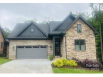 Charming single-Gathering home boasting a stone and brick facade, a gray roof, and a well-manicured lawn at 5100 Silver Trace Ln, Denver, NC 28037
