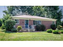 Charming brick home features a well-manicured lawn and landscaping at 616 26Th Nw St, Hickory, NC 28601