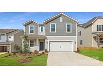 Charming two-story home features a two-car garage, blue door, and manicured front lawn at 6301 Fairfax Ct, Maiden, NC 28650