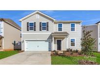 Charming two-story home with a garage, featuring a well-maintained lawn and classic design elements at 6337 Fairfax Ct, Maiden, NC 28650