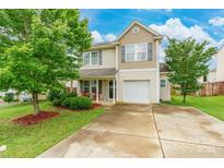 Charming two-story home features a well-manicured lawn and inviting front porch, blending curb appeal with a cozy atmosphere at 693 Carybrook Ct, York, SC 29745