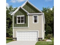 Charming two-story home features a convenient one-car garage and a mix of vertical and horizontal siding at 750 Kitfox Nw Dr, Concord, NC 28027