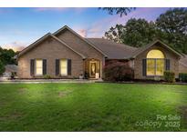 Charming brick home with well-manicured lawn and inviting entrance with an American flag at 800 Isle Of Palms Ct, Fort Mill, SC 29708