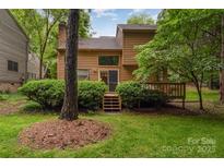 Charming two-story home featuring a spacious deck and lush greenery in the backyard at 8968 St Croix Ln, Charlotte, NC 28277