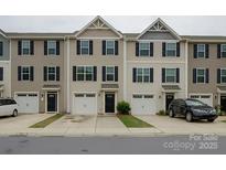 A view of the townhome complex featuring individual garages and covered front door entries at 954 Taybyn Rd, Fort Mill, SC 29715