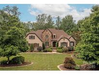 Stunning home featuring stone accents, a manicured lawn, and lush landscaping at 1032 Seminole Dr, Waxhaw, NC 28173