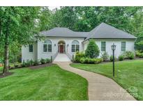 Charming single-story home with landscaped front yard and welcoming entrance at 14831 Charterhouse Ln, Huntersville, NC 28078