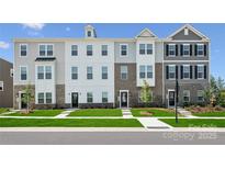 Modern townhome featuring a mix of brick and siding, complimented by neatly manicured landscaping at 1940 Westerhill Dr, Fort Mill, SC 29708