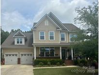Charming two-story home featuring an attached two-car garage, manicured lawn, and inviting front porch at 2010 Brightflower Ln, York, SC 29745