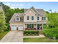 Charming two-story home with a manicured lawn, lovely landscaping, and a three-car garage at 2010 Brightflower Ln, York, SC 29745