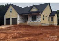 New construction exterior with a two-car garage and covered porch, showcasing modern design and quality craftsmanship at 2589 Polo Ln, Maiden, NC 28650