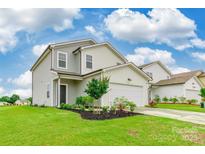 Charming two-story home with manicured lawn, lush landscaping, and attached two-car garage at 3073 Langhorne Sw Ave, Concord, NC 28027
