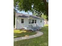 Charming painted brick home featuring a walkway and a cozy covered front porch at 317 Heilig Ave, Salisbury, NC 28144